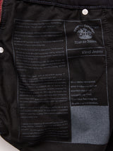 Close-up of the inside pocket of Blue de Gênes Vinci Venom Blk Jeans - Dark Denim, featuring printed text about Vinci Jeans and Leonardo da Vinci, along with a crest logo and product details in white ink on black comfort stretch twill fabric. Proudly made in Italy.