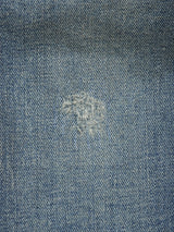 Close-up of Repi Dark Vintage Jeans by Blue de Gênes in mid blue denim, showing comfort stretch fabric with a visibly mended patch and textured stitching on these regular slim-fit jeans.