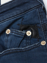Close-up of Blue de Gênes Repi BlueBlk Used Jeans in blue-black comfort stretch denim, showing a small pocket inside the larger front one, gold rivets, and a black leather patch near the top seam.
