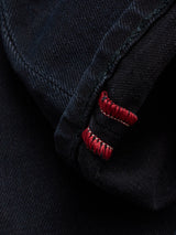 A close-up of the cuff of Blue de Gênes Recco BlueBlk Jeans in blue black denim highlights detailed stitching and red thread accents—ideal for fans of tapered leg jeans.