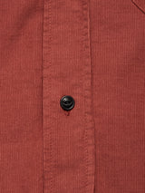 Close-up of the Zamboni Velu Shirt in henna by Blue de Gênes, showcasing rust-colored baby corduroy with vertical ridges and a signature black button on the placket.