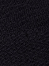 Close-up of dark, finely knit fabric with a visible horizontal seam running across the center, characteristic of the Boshi Beanie - Dark Navy by Blue de Gênes, crafted from Merino wool and knitted in Denmark.