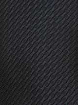 Close-up of the Nekutaki Tie #A - Navy by Blue de Gênes, featuring a black textured fabric surface with a repeating diamond or honeycomb pattern that creates a subtle, geometric, three-dimensional effect—an ideal detail for this classic men’s accessory.