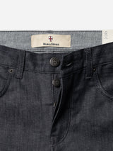 Close-up of the Blue de Gênes BGleroy Jeans in raw denim, highlighting their classic five-pocket design and button fly with three embossed buttons, plus an inner waistband label reading Blue de Gênes. These jeans feature innovative construction with no outer leg seam, creating a clean, streamlined silhouette.