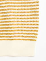 Close-up of the BGbob Knit Polo - Sunflower by Blue de Gênes, a cotton knit polo showcasing horizontal mustard yellow and white stripes, finished with a solid off-white ribbed hem at the bottom.