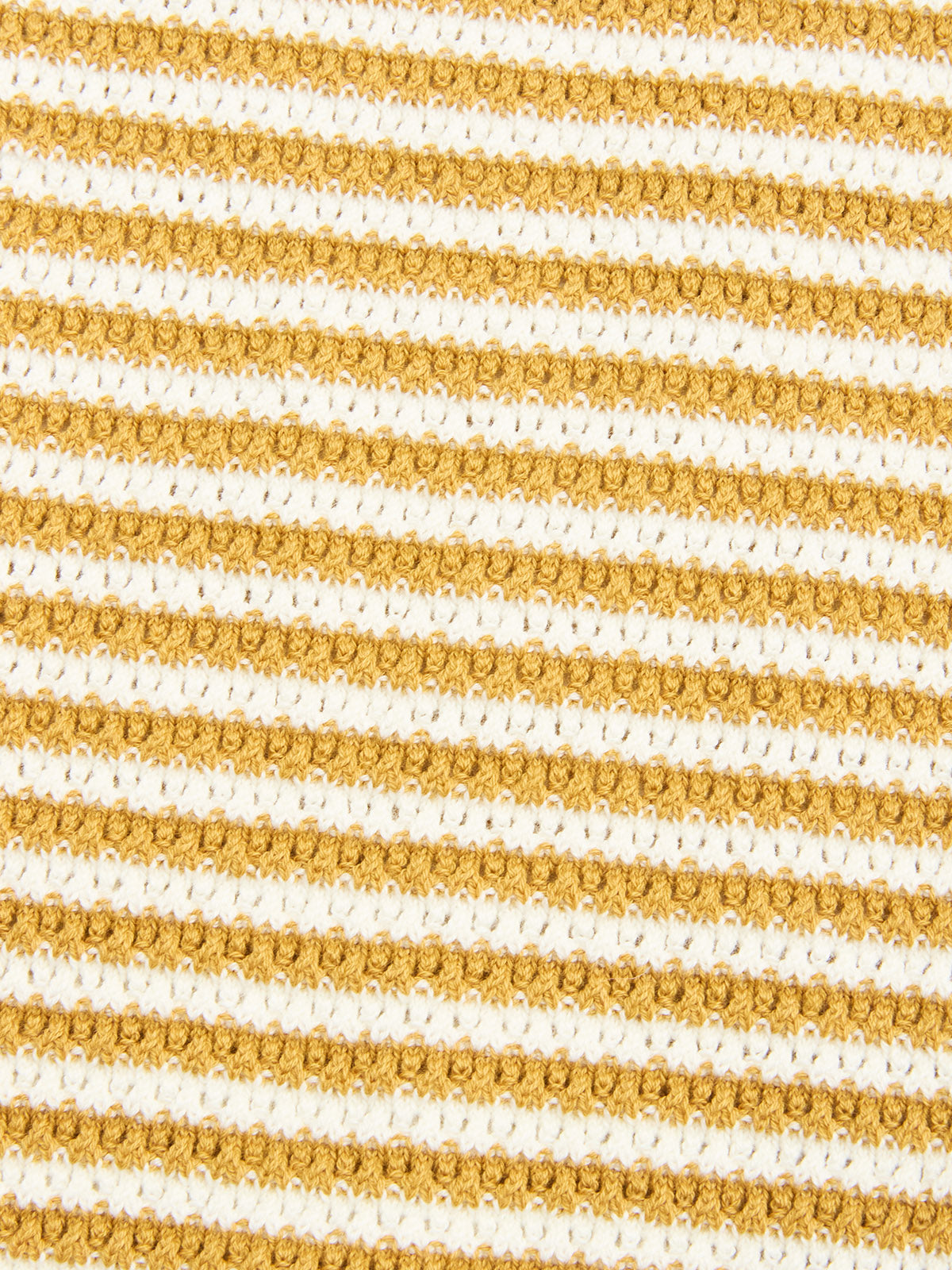 A detailed view of the BGbob Knit Polo - Sunflower by Blue de Gênes, featuring textured cotton knit with alternating gold and white horizontal stripes in a repeating pattern.