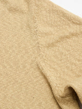 Close-up of the Blue de Gênes BGyale Slubby Crewneck Knit in pale khaki, highlighting its detailed seam stitching and a gently folded sleeve, set against a white background.