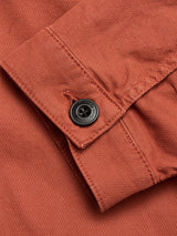 Close-up of the BGpontus Teo Overshirt in Copper Brown by Blue de Gênes, showcasing the honeycomb cotton cuff with a black button fastened. The textured weave and stitching highlight the details of the relaxed fit sleeve and button.