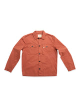 The BGpontus Teo Overshirt by Blue de Gênes, shown in copper brown, features a relaxed fit with long sleeves, two chest pockets, and black buttons. Crafted from honeycomb cotton fabric, the shirt is displayed laid flat on a white background.
