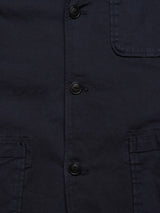 Close-up of the Blue de Gênes Gabbiano Dobby Blazer - Dark Navy, featuring four black center buttons, visible stitching on two flap and one chest pocket, crafted from cotton comfort stretch for easy movement.