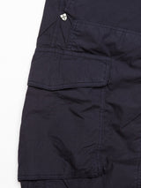 Close-up of the Mustang Cargo Pant in navy by Blue de Gênes, showing a cargo pocket with visible stitching and a small metallic badge near the top seam.