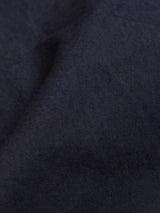 A close-up of the Mustang Cargo Pant - Navy by Blue de Gênes shows dark blue textured fabric with a soft, diagonal fold.