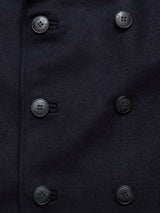 Close-up of the Peacoat - Dark Navy by Blue de Gênes, showcasing its dark wool fabric and double-breasted design with two rows of black buttons.