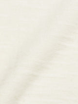 Close-up of Monte Knit - Whitecap by Blue de Gênes, featuring light beige textured fabric with gentle folds and a slightly uneven, soft surface for a natural look.