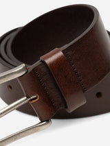 Close-up of the BGathol Belt - Dark Brown by Blue de Gênes, a handmade full-grain leather belt from Italy featuring a classic metal buckle and loop, highlighted by its textured surface and detailed stitching.