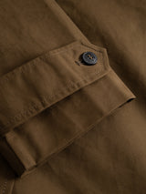 Close-up of the BGjacques AW Coat - Brown by Blue de Gênes, featuring a buttoned cuff crafted from heavy cotton fabric. The detailed stitching and single dark button highlight the coat’s durability and timeless workwear style.