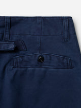 Close-up of the back pocket on the BGliam Nebraska Chino - Blue by Blue de Gênes, showcasing a button closure and visible stitching details on navy blue cotton fabric.