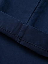 Close-up of the BGliam Nebraska Chino in Blue by Blue de Gênes, featuring dark blue fabric with visible seams and stitching. The high-density dobby weave enhances durability and adds a refined finish, highlighting the texture and construction details of these premium chinos.