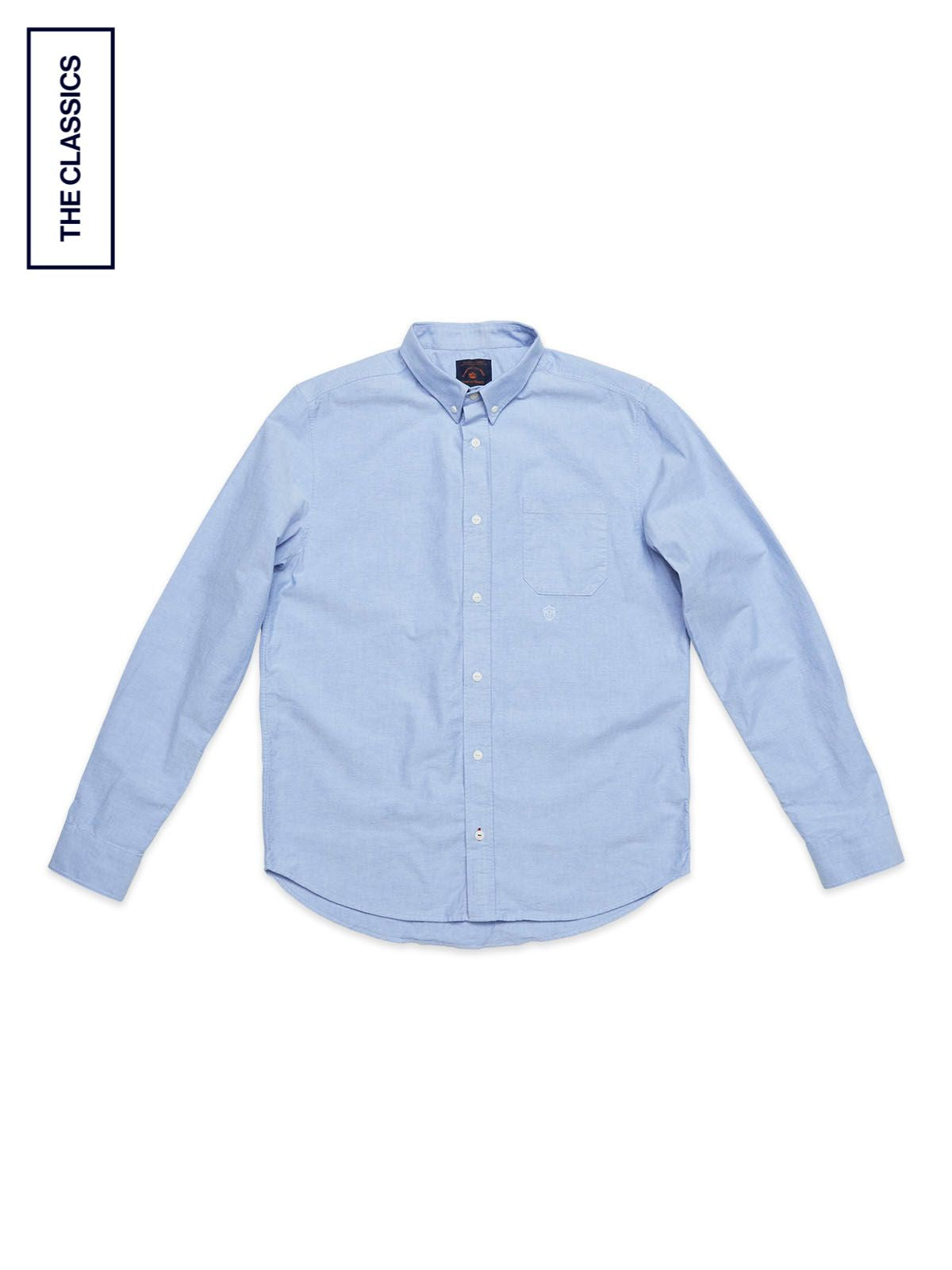 The Blue de Gênes BGsandro Oxford Shirt in blue is laid flat on a white background. This long-sleeve button-down features a front pocket, classic collar, and 