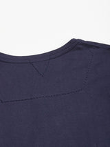 Close-up of the back neckline of the Sagi Nuovo T-shirt in Dark Navy by Blue de Gênes, highlighting visible stitching and seams on smooth fabric against a white background—a true men’s wardrobe staple designed for everyday comfort.