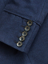 Close-up of the Casella Officers Blazer - Dark Navy by Blue de Gênes, showing the sleeve with four black buttons featuring gold "blue genus" text around the edge, sewn in a neat row near the cuff.