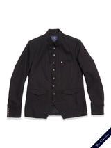 The Casella Officers Blazer by Blue de Gênes is a black brushed cotton blazer featuring a button-up front, chest pocket, two flap pockets, and buttoned cuffs, shown laid flat on a white background with "The Classics" label in the corner.