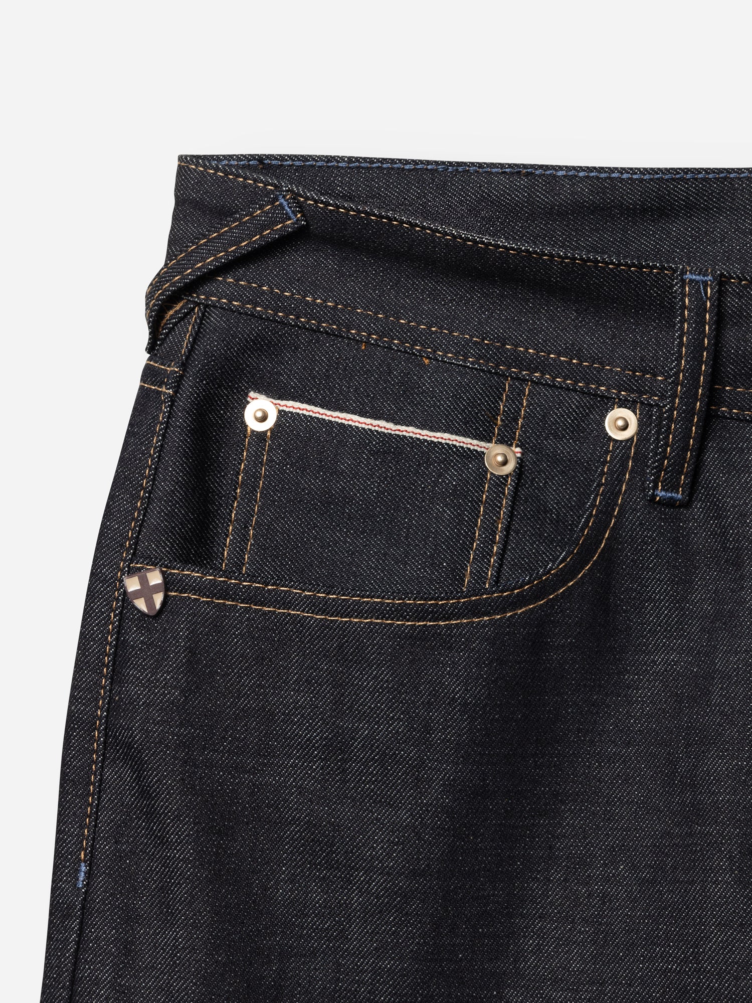 Blue de Gênes BGgiacomo Selvedge V3 Jeans - Raw Denim in dark indigo with a relaxed loose fit, featuring a coin pocket with selvedge trim and a small metal shield-shaped logo emblem.