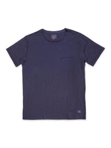 The Sagi Nuovo T-shirt in Dark Navy by Blue de Gênes is a regular-fit, short-sleeve shirt featuring a small chest pocket on the left side and a discreet logo tag near the bottom hem. Crafted from premium cotton, this essential men’s staple is laid flat on a white background.