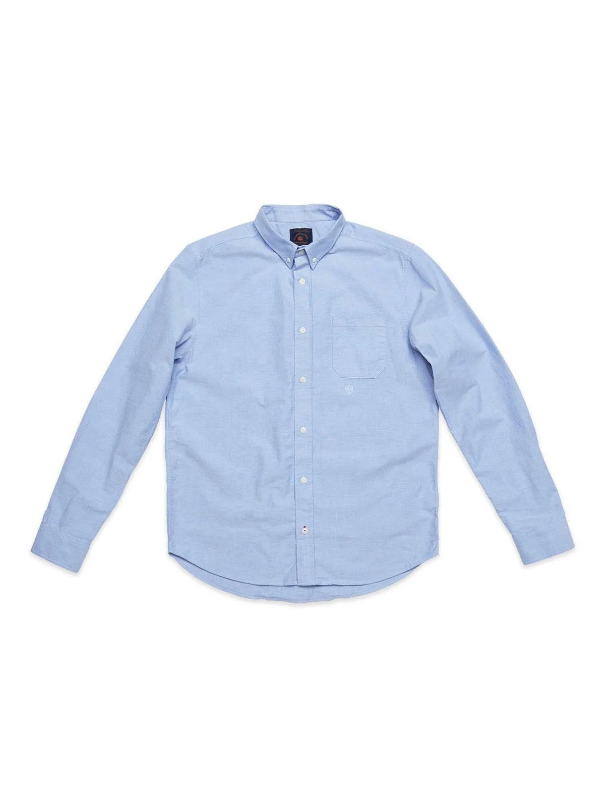 The BGsandro Oxford Shirt - Blue by Blue de Gênes is a light blue, long-sleeve shirt featuring a collar and a front chest pocket, displayed on a white background.