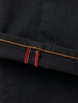 Close-up of a black BGpaulo Pavia V3 Chino pant leg cuff, featuring a gold stitched hem and red vertical decorative stitching.