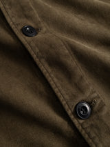 Close-up of the BGbarnaba Iro Overshirt in Beech Green by Blue de Gênes, featuring detailed corduroy texture and stitching, with two black buttons sewn onto the workwear-inspired design.