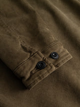 Close-up of a Beech Green, workwear-inspired fabric sleeve from the BGbarnaba Iro Overshirt by Blue de Gênes, featuring two black buttons on the cuff and showcasing the textured weave and fine stitching detail.