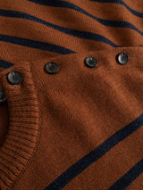 Close-up of the BGdaw Stripe Knit - Ginger Bread Orange crewneck sweater by Blue de Gênes, featuring a brown and black striped design with five dark buttons along the shoulder seam, showcasing the texture and details of the 100% wool fabric.