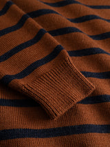 Close-up of the Blue de Gênes BGdaw Stripe Knit in Ginger Bread Orange, highlighting its brown crewneck design with black horizontal stripes, the detailed texture of its 100% wool fabric, and the ribbed cuff of the sleeve.
