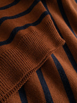 A close-up of the BGdaw Stripe Knit - Ginger Bread Orange by Blue de Gênes, showcasing its 100% wool knitted fabric with dark orange and navy blue horizontal stripes in a classic crewneck sweater design, featuring ribbed cuffs and visible textured detail.