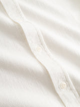 Close-up of the BGenrico Tessusto Shirt in Chalk by Blue de Gênes, featuring a white honeycomb-textured cotton fabric and a row of corozo buttons down the center.