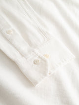 Close-up of the BGenrico Tessusto Shirt in Chalk by Blue de Gênes, featuring a white honeycomb-textured cotton cuff with two white corozo buttons. The soft, slightly ribbed fabric highlights the careful detailing and stitching of the cuff area as it lays flat.