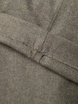 Close-up of a seam on grey melange herringbone fabric, showcasing the detailed stitching and textured weave. The straight seam, with visible thread and fabric grain, highlights the precise craftsmanship found in Blue de Gênes’ BGkyoto Wool Pant - Grey Mel—a relaxed yet tailored trouser with a refined straight-leg silhouette.
