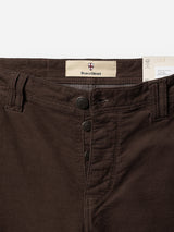 Close-up of the waistband and button fly on the BGpaulo Ottawa V3 Trousers in Hot Fudge Brown, featuring the Blue de Gênes branding tag and three black buttons adorned with a shield emblem. These regular slim fit pants highlight refined details and quality craftsmanship.