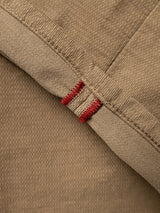Close-up of sepia tint brown fabric with two parallel red stitches on a seam, highlighting the texture and detail in the weave and stitching—typical of Blue de Gênes BGpaulo Ottawa V3 Trousers designed for a regular slim fit.
