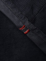 Close-up of dark navy denim fabric from the Blue de Gênes BGpaulo Ottawa V3 Trousers, with a folded edge revealing a selvedge seam and distinctive red and white stitching—details evocative of the refined finishes found on premium slim fit styles.