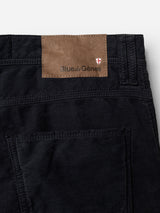 Close-up of the back of BGpaulo Ottawa V3 Trousers in dark navy, featuring a brown leather patch above the pocket with the Blue de Gênes brand name and a small red and white shield logo.