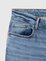 Close-up of the waistband and front pocket of BGvinci Pala Used V3 Jeans - Denim Blue, featuring comfort stretch denim and a small checkered emblem.