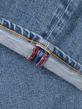Close-up of a BGvinci Pala Used V3 Jeans - Denim Blue comfort stretch denim cuff featuring gold stitching and red interior seam detail.