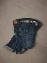 Relaxed fit BGmarco Sioux Jeans - Used in dark blue denim with a distressed finish, tan leather waist patch, and striped interior lining.