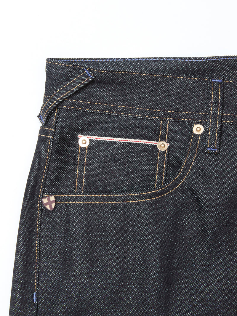Close-up of the Giacomo Selvedge V2 Jeans by Blue de Gênes, featuring rigid raw denim, front and coin pockets with white and pink stitching, bronze rivets, a visible belt loop, and contrasting yellow stitching.