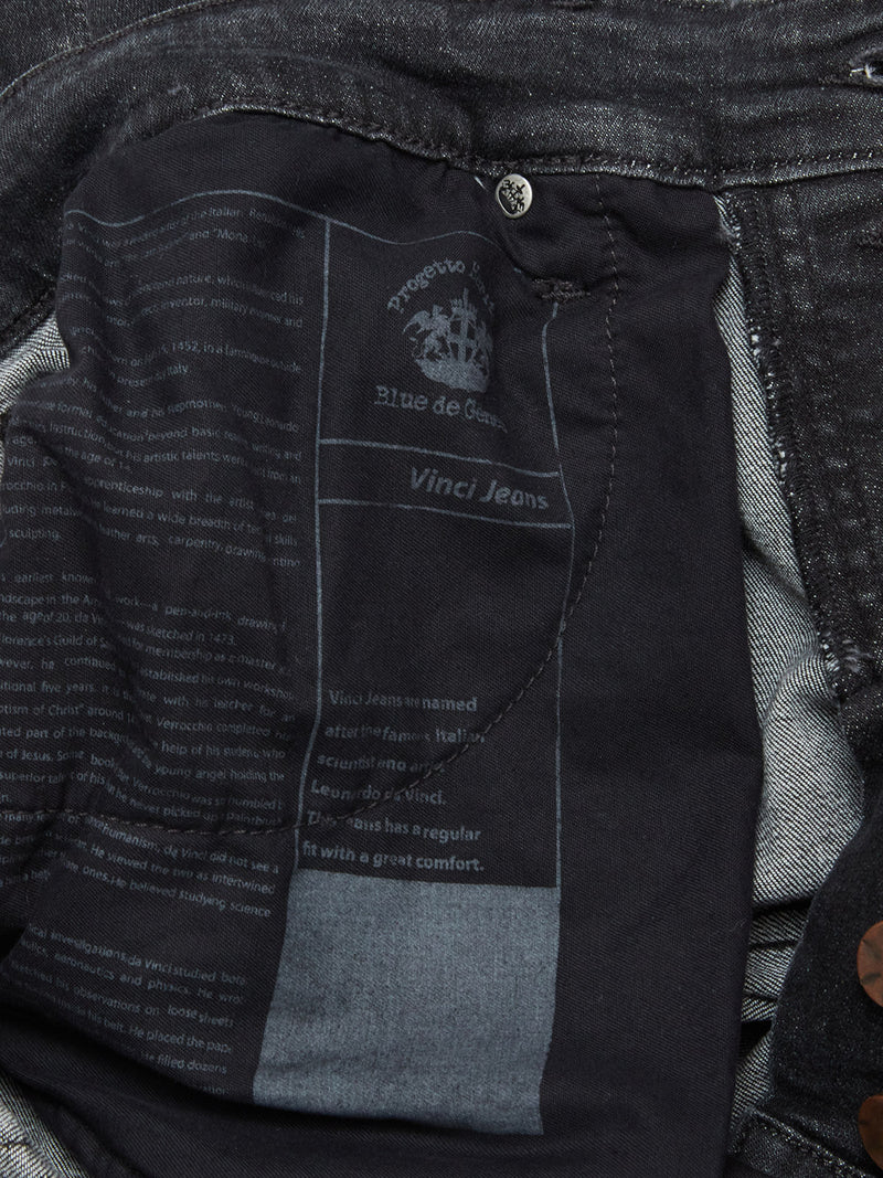 Close-up of the inside pocket of Blue de Gênes Vinci G Dark Grey Jeans in grey denim, featuring black fabric with white printed text, a crest logo, comfort stretch details, and made in Italy branding.