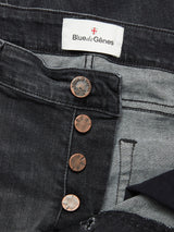 Close-up of Blue de Gênes Vinci G Dark Grey Jeans in grey denim, featuring comfort stretch, regular fit, a partially open button fly with copper buttons, and a white brand label sewn onto the waistband.