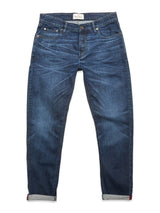 The Vinci Used Jeans - Used by Blue de Gênes are blue regular fit jeans with a classic five-pocket design, cuffed hems, and subtle fading and whiskering. Made from comfort stretch denim, they are shown laid flat on a white background.