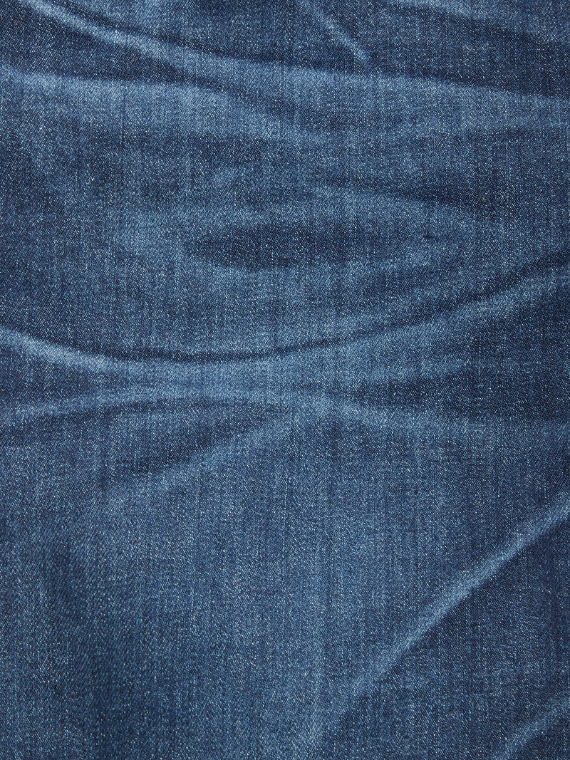 Close-up view of Vinci Used Jeans - Used by Blue de Gênes, showcasing blue comfort stretch denim with visible texture, stitching, and natural creases highlighting light and dark patterns on the fabric.